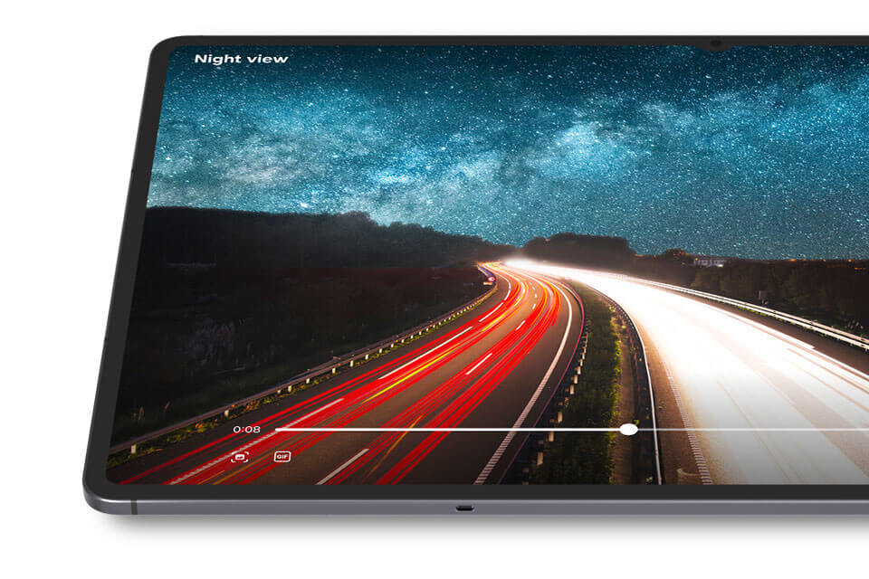 Fragment ekranu Galaxy Tab S11 pokazujący przyspieszone nagranie wideo przedstawiające obiekt na drodze i tekst. Pojemność baterii 8400 mAh i możliwość oglądania filmów do 18 godzin, co podkreśla długi czas pracy baterii, umożliwiający dłuższe użytkowanie przez cały dzień. Obraz przedstawia tablet z wyświetlaczem pokazującym nocny widok autostrady z jasnymi smugami świateł samochodów i gwiaździstym niebem. Na ekranie widoczny jest tekst \'Night view\' oraz pasek postępu wideo z czasem 0:08.