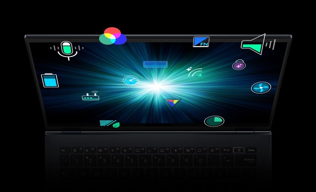 Obraz przedstawia otwarty laptop z wyświetlaczem pokazującym jasny, promienisty efekt świetlny na czarnym tle. Na ekranie widoczne są różne kolorowe ikony, takie jak mikrofon, bateria, głośnik i inne symbole technologiczne.