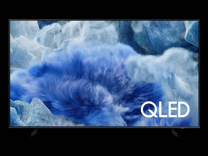 Telewizor wyświetla obraz z niebieskimi i białymi abstrakcyjnymi wzorami przypominającymi chmury i lód. W prawym dolnym rogu ekranu widoczny jest napis \'QLED\'.