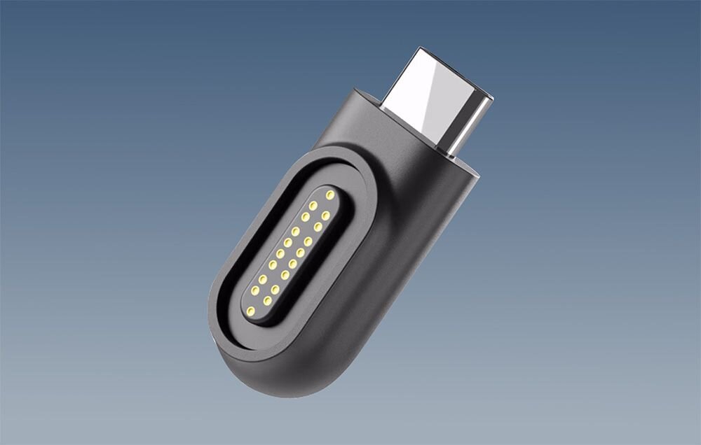Obraz przedstawia czarne złącze magnetyczne z końcówką USB-C, z widocznymi złotymi pinami na tle niebieskiego gradientu.
