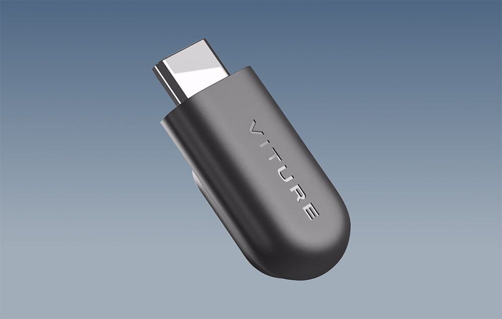 Obraz przedstawia złącze magnetyczne Viture do adaptera USB-C w kolorze ciemnoszarym, z widocznym napisem \'VITURE\' na obudowie.