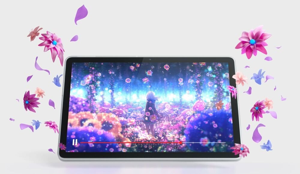 Tablet wyświetla kolorową animację z postacią wśród kwiatów, a wokół ekranu unoszą się trójwymiarowe kwiaty. Tło jest jasne, a tablet ma szarą ramkę.