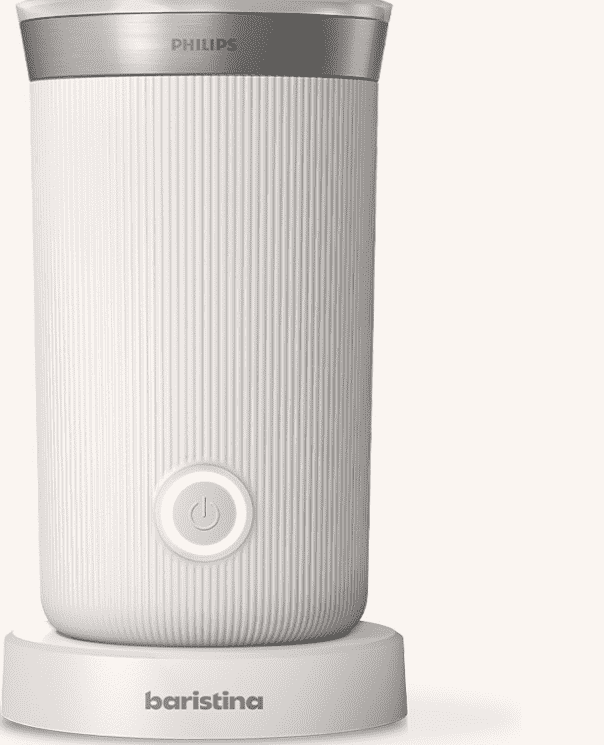 Biały spieniacz do mleka z pionowymi żłobieniami, posiada przycisk zasilania na froncie. Na górze widoczne jest logo \'PHILIPS\', a na podstawie napis \'baristina\'.