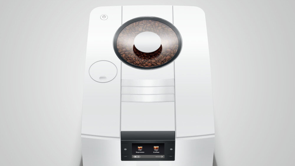 Biały ekspres do kawy z okrągłym pojemnikiem na ziarna kawy na górze. Na wyświetlaczu widoczne są ikony z napisami \'Espresso\' i \'Coffee\'.
