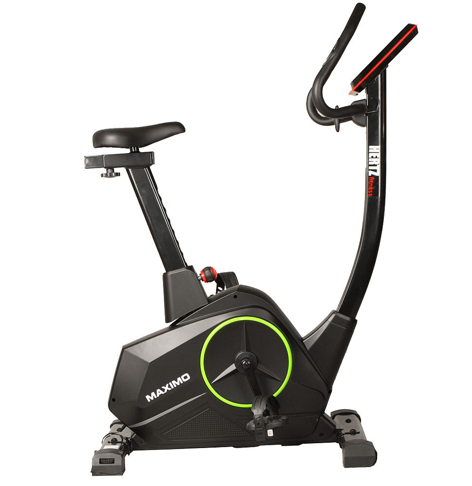Na obrazie widoczny jest rower elektromagnetyczny z napisem \'MAXIMO\' na obudowie oraz logo \'HERTZ fitness\' na kierownicy. Rower ma czarną ramę z zielonym akcentem wokół koła zamachowego.