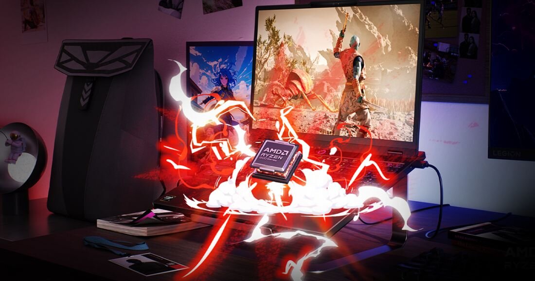 Na biurku znajduje się laptop z wyświetlonym na ekranie dynamicznym obrazem z gry, a przed nim unosi się procesor AMD Ryzen otoczony efektami świetlnymi. Obok laptopa stoi czarny plecak z geometrycznym wzorem.