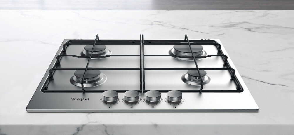 Płyta gazowa z czterema palnikami i metalowymi pokrętłami na przednim panelu. Widoczne logo: Whirlpool.