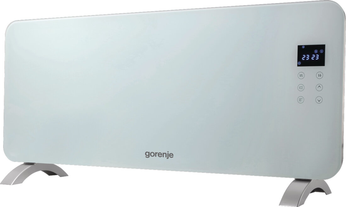 Grzejnik konwektorowy z logo \'gorenje\' na dole, posiada cyfrowy wyświetlacz z temperaturą \'23\' oraz przyciski dotykowe obok. Urządzenie ma nowoczesny, biały design i stoi na metalowych nóżkach.