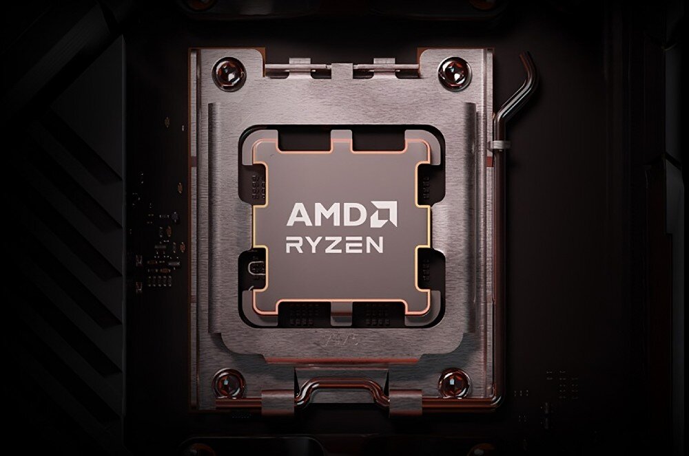 Na obrazie widoczny jest procesor z napisem \'AMD RYZEN\' zamontowany w gnieździe płyty głównej. Procesor otoczony jest metalowym mocowaniem z czterema śrubami.