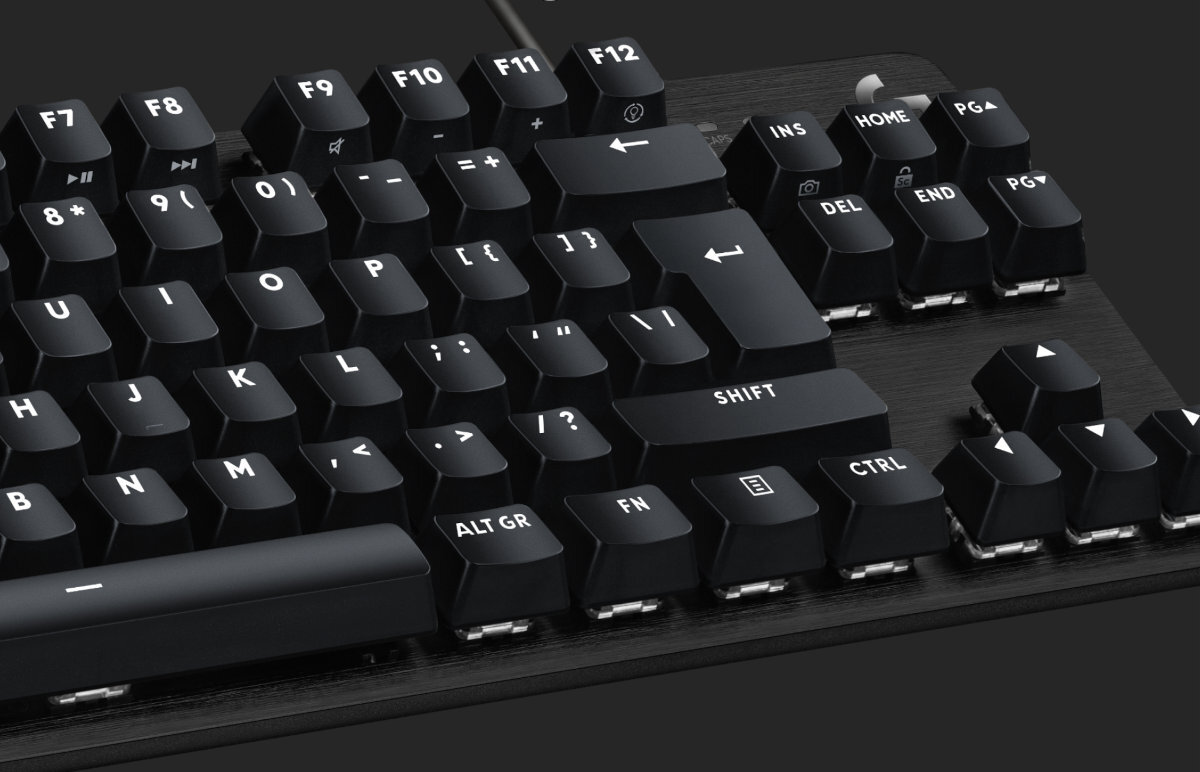 Czarna klawiatura mechaniczna z widocznymi klawiszami funkcyjnymi F7 do F12 oraz klawiszami numerycznymi i strzałkami. Klawisze mają białe oznaczenia, a powierzchnia klawiatury jest matowa.