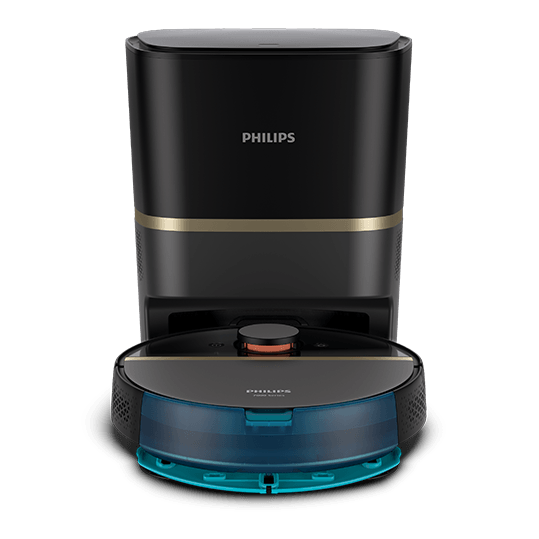 Na obrazie widoczny jest czarny robot sprzątający z niebieskim elementem z przodu, stojący przed stacją dokującą. Na obu urządzeniach znajduje się logo \'PHILIPS\'.