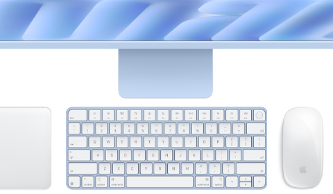 Na obrazie widoczny jest komputer typu All in One z klawiaturą i myszką w kolorze jasnym. Na klawiaturze znajduje się logo producenta w postaci nadgryzionego jabłka.