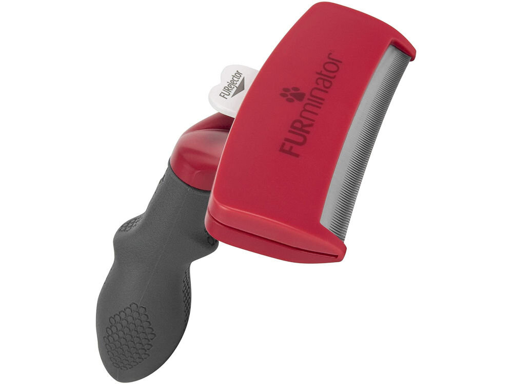 Szczotka FURMINATOR T691694 Czerwono-czarny dla pupila szczotka leżąca bokiem czerwona głowica czarna rączka przycisk ostrze białe tło