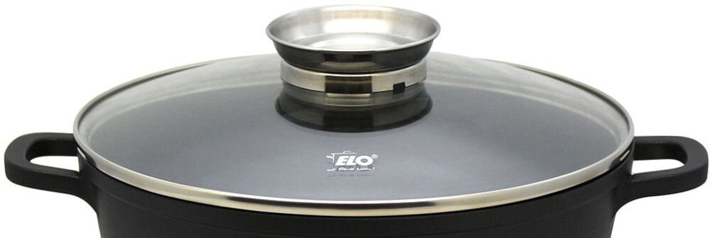 Patelnia ELO Alucast 8667426 24 cm pokrywka srebrna obręcz srebrny uchwyt białe tło wszechstronność na wszystkich typach płyt grzewczych indukcja ceramika elektryczne gazowe halogenowe praktyczna, szklana pokrywka kontrola gotowania możliwość mycia w zmywarce Elegancki, czarny design stylowo się prezentuje 