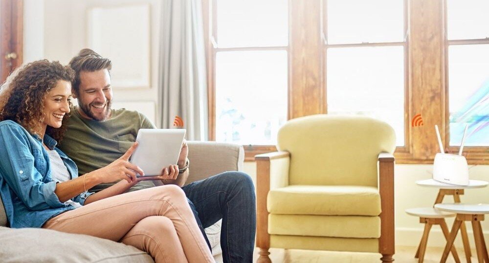 Router TENDA 4G06 Para w mieszkaniu, oglądają coś na tablecie, na stoliku router 4G06