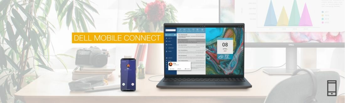 Na biurku znajduje się laptop z otwartym ekranem, obok którego stoi smartfon. Na ekranie laptopa widoczne są aplikacje, a nad nim napis \'DELL MOBILE CONNECT\'.