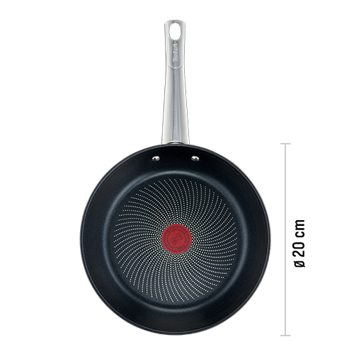 Na obrazie widoczna jest czarna patelnia z metalicznym uchwytem i czerwonym okrągłym wzorem na środku dna. Na uchwycie znajduje się logo \'Tefal\'.