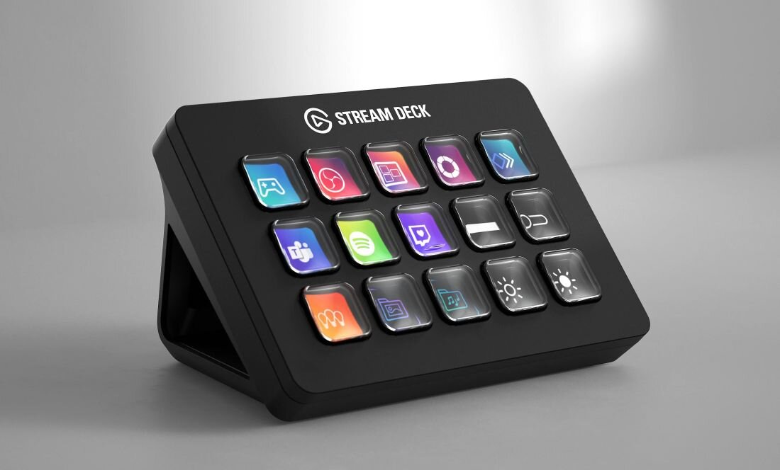 Panel Elgato Stream Deck z piętnastoma przyciskami LCD stoi pod kątem na szarym tle, prezentując kolorowe ikony funkcji 