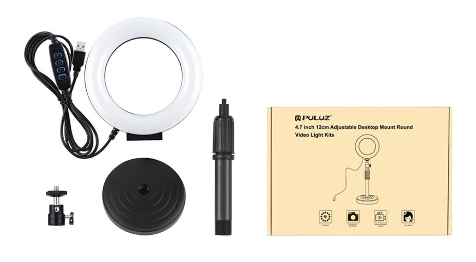 Na obrazie znajduje się lampa pierścieniowa LED z regulowaną podstawką oraz akcesoria, takie jak kabel USB z kontrolerem, uchwyt i podstawka. Obok znajduje się pudełko z napisem \'PULUZ 4.7 inch 12cm Adjustable Desktop Mount Round Video Light Kits\'.