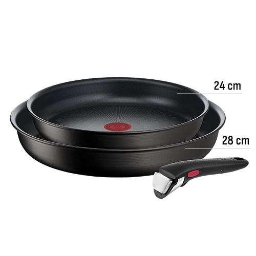 Na obrazie widoczne są dwie czarne patelnie z czerwonym okrągłym wzorem na środku oraz odłączana rączka z czarnym uchwytem i czerwonym przyciskiem.