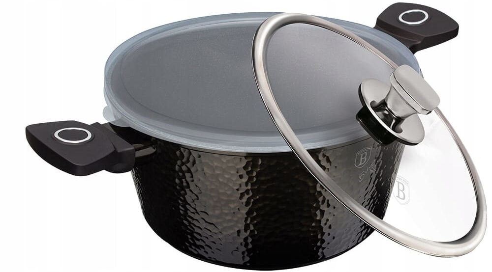Garnek BERLINGER HAUS Primal Gloss Collection BH-6573 28 cm garnek stoi bokiem czarny przykryty jasną pokrywką obok podparta jest szklana pokrywka ze srebrnymi elementami białe tło uniwersalne naczynie kuchenne na wszystkich typach kuchenek gazowe elektryczne ceramiczne halogenowe indukcyjne system TURBO INDUCTION skrócenie czasu gotowania wygodne rozwiązanie