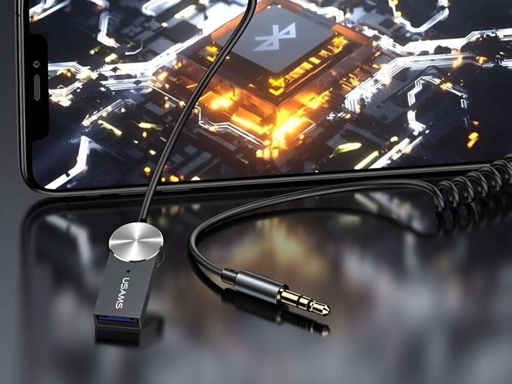 Adapter audio USAMS US-SJ464 Bluetooth
            adapter obok telefonu bezprzewodowe odtwarzanie zestaw głośnomówiący jack aux usb bluetooth