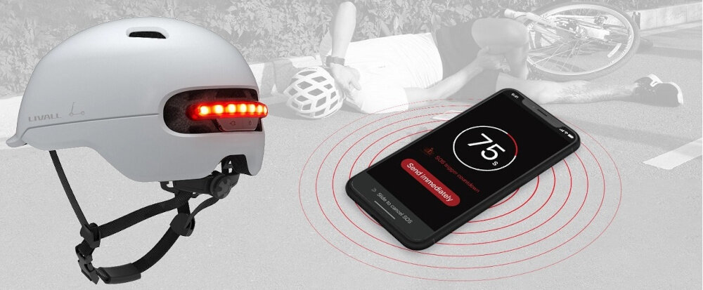 Kask LIVALL C20 Biały (rozmiar L) szare tło kask widoczny od tyłu pod skosem obok telefon w tle leży osoba na drodze zaawansowany detektor upadku bezpłatna aplikacja Livall Riding jeśli po wypadku kask pozostaje w bezruchu przez 10 sekund uruchamia 90-sekundowe odliczanie wysłanie Alertu SOS do wskazanego kontaktu przybliżoną lokalizacją GPS telefonu na systemy Android i iOS