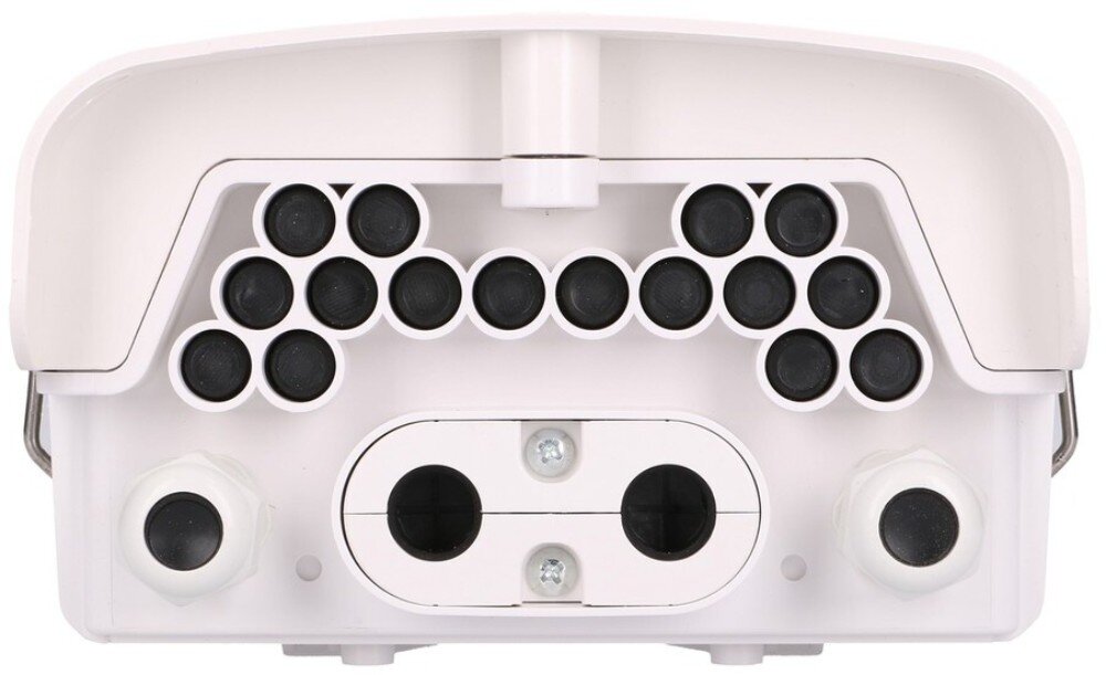 Puszka połączeniowa EXTRALINK EX.18945 Widok na dolny panel urządzenia wykonanego z tworzywa sztucznego, który zawiera szesnaście małych czarnych gumowych zaślepek ułożonych w rzędy, dwa duże białe dławiki po bokach oraz środkowy owalny otwór na przewody przykręcony dwiema śrubami