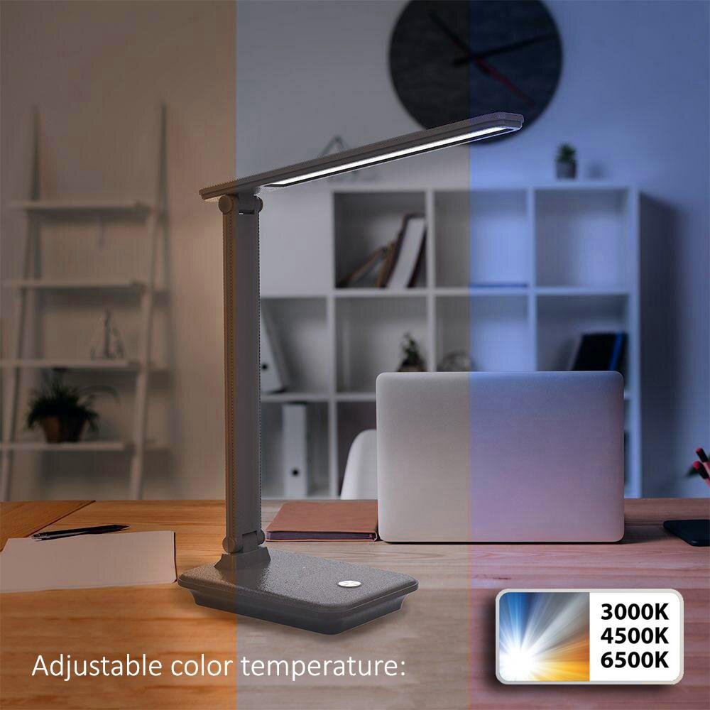 Na biurku znajduje się czarna lampka biurkowa LED z możliwością regulacji temperatury barwowej. Widoczny jest tekst: \'Adjustable color temperature: 3000K 4500K 6500K\'.