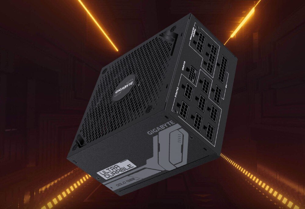 Zasilacz GIGABYTE UD1300GM PG5 Czarne urządzenie w kształcie prostopadłościanu z logo producenta i napisem 'Ultra Durable', widoczne liczne gniazda modularne z jednej strony, ustawione na tle pomarańczowego światła, opis