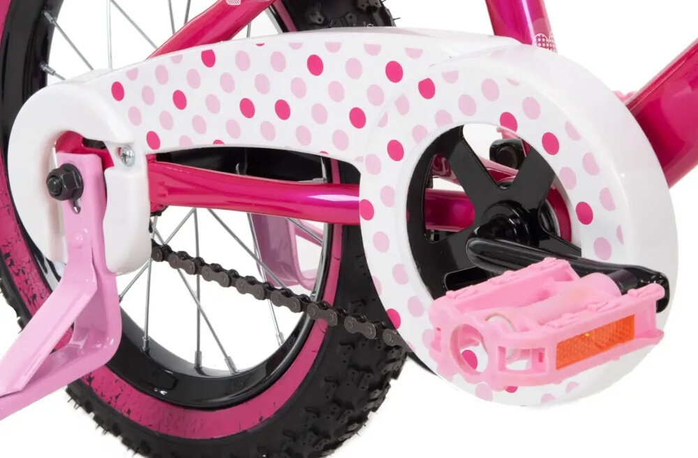 Rower dziecięcy HUFFY Disney Minnie 14 cali dla dziewczynki Różowy zbliżenie na osłonę łańcucha zdjęcie na białym tle boczne kółka asekurują dziecko w początkowej fazie nauki boczne kółka można łatwo usunąć osłona łańcucha kolorowa grafika w kropki zabezpiecza łańcuch przed brudem
