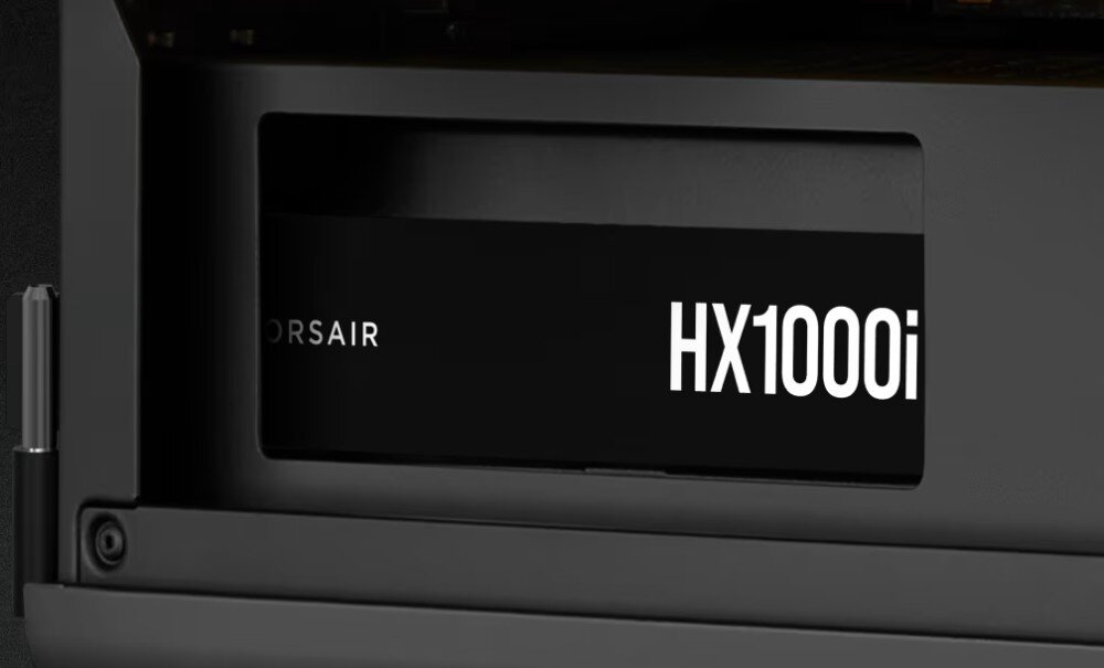 Zasilacz CORSAIR HX1000i Zbliżenie na boczny panel obudowy z widocznym napisem 'HX1000i' na czarnej obudowie zasilacza