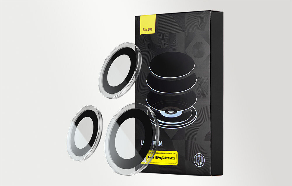 Na obrazie widoczne są trzy okrągłe elementy szklane oraz opakowanie z napisem \'Baseus\' i \'Lens Film\'.
