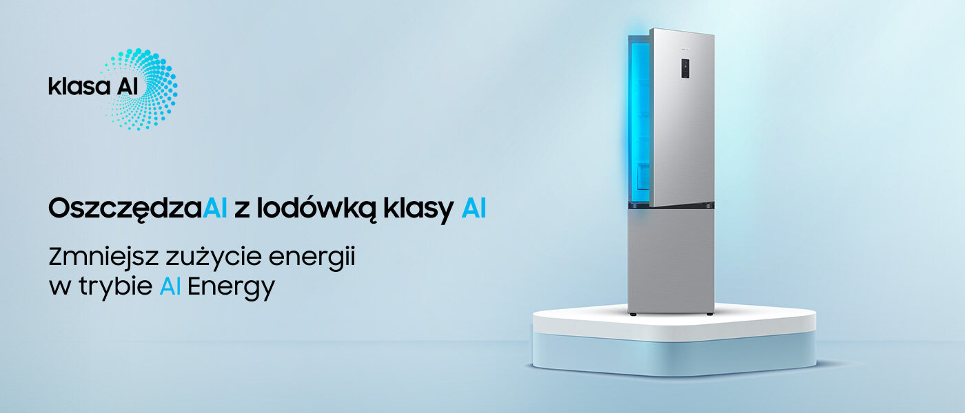 Na obrazie widoczna jest lodówka w metalicznym grafitowym kolorze, stojąca na białej platformie. Obok znajduje się tekst: \'klasa AI Oszczędzaj z lodówką klasy AI Zmniejsz zużycie energii w trybie AI Energy\'.