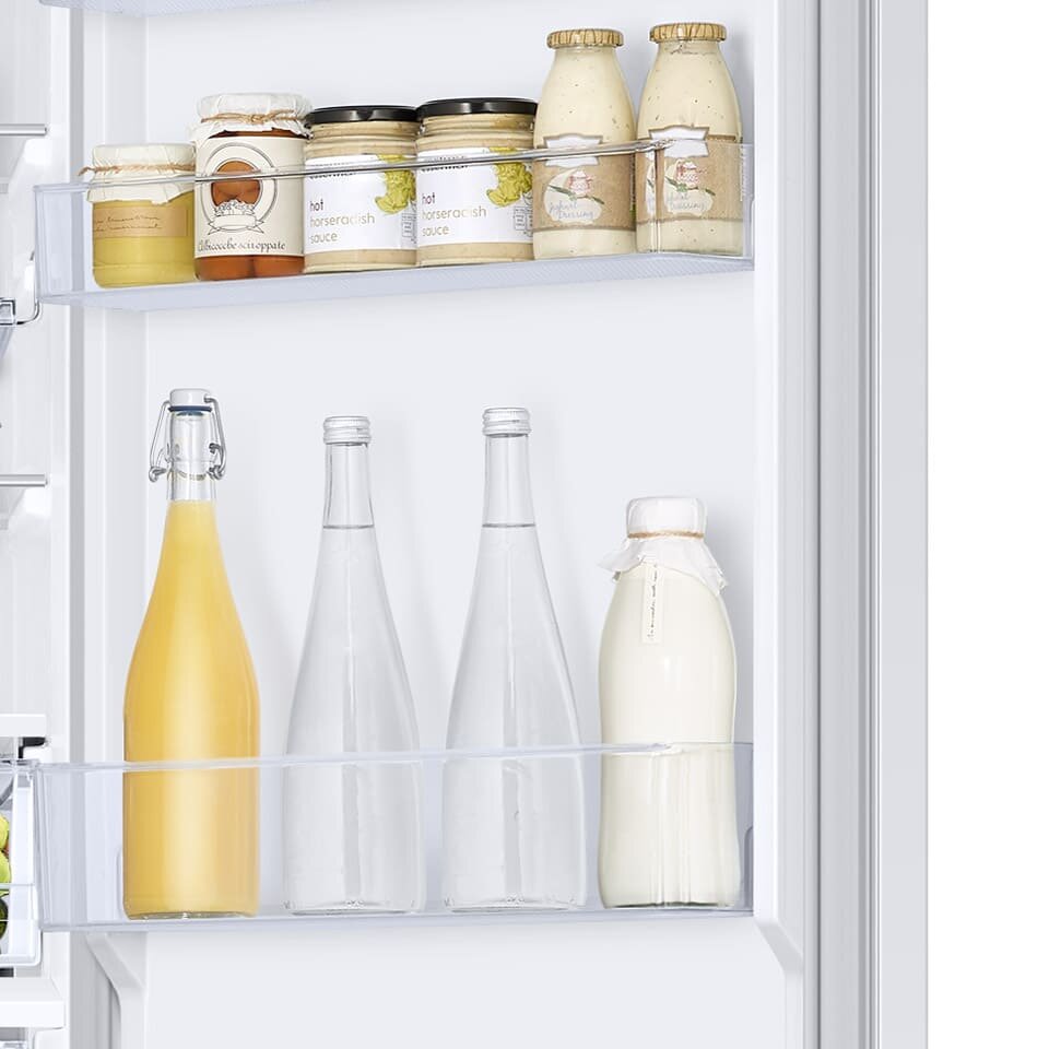 Zdjęcie drzwi chłodziarki z umieszczonymi tu pojemnikami, w których wygodnie przechowasz słoiki z przetworami i butelki z mlekiem Zdjęcie drzwi chłodziarki z umieszczonymi tu pojemnikami, w których wygodnie przechowasz słoiki z przetworami i butelki z mlekiem