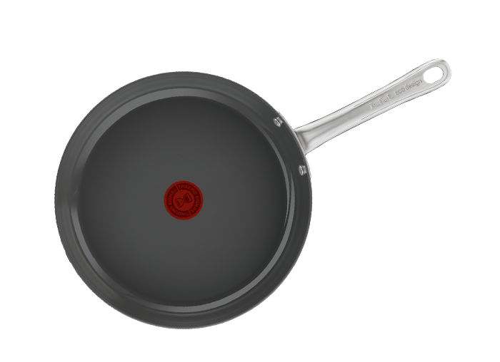 Na obrazie widoczna jest patelnia z ciemnym wnętrzem i metalowym uchwytem. Na środku patelni znajduje się czerwony okrągły symbol z tekstem \'THERMO-SPOT\'.