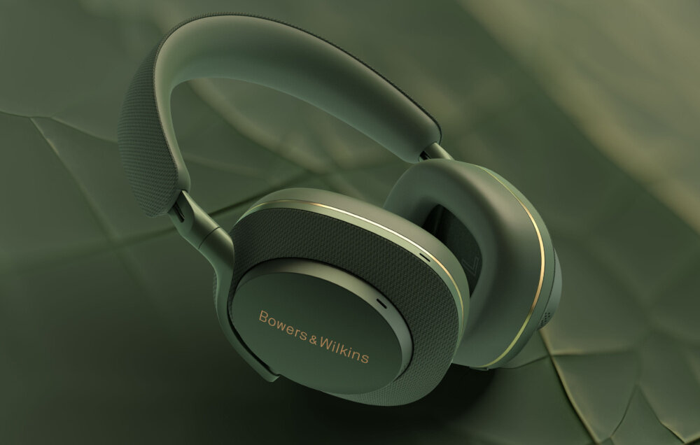 Zielone słuchawki nauszne z widocznym napisem \'Bowers & Wilkins\' na nauszniku. Tło jest w odcieniach zieleni, pasujące do koloru słuchawek.