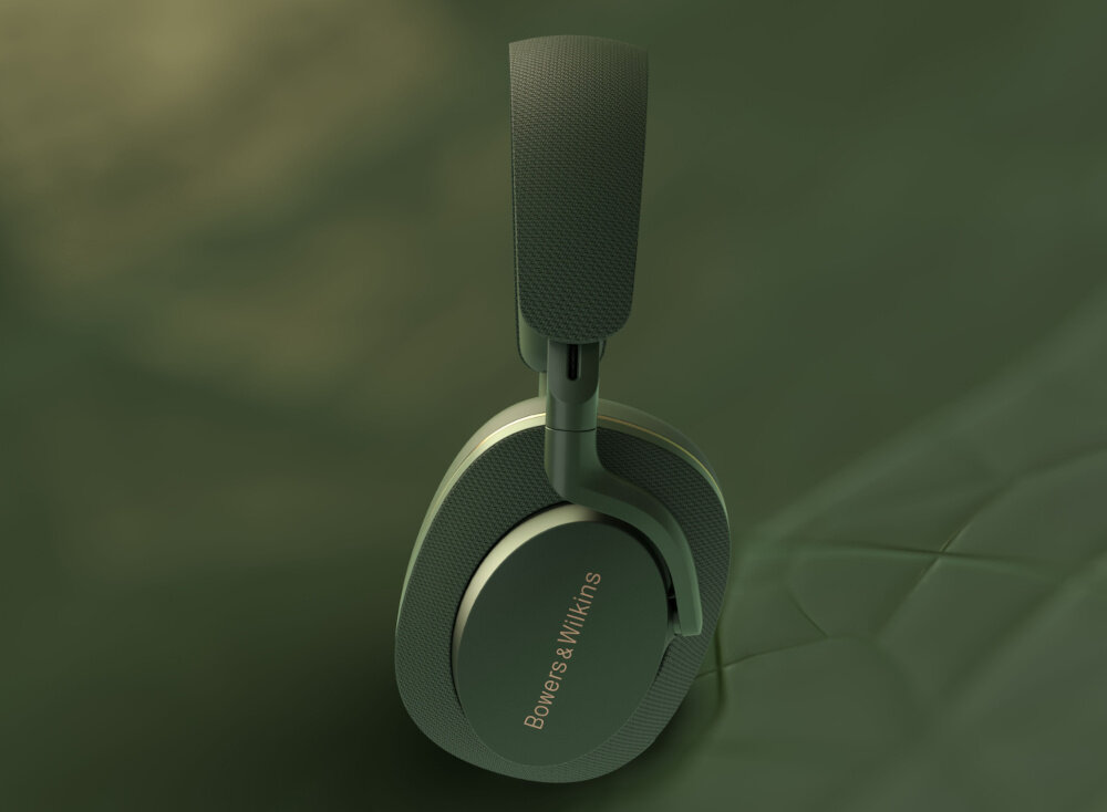 Zielone słuchawki nauszne z widocznym napisem \'Bowers & Wilkins\' na nauszniku. Tło jest również zielone, co podkreśla kolor słuchawek.