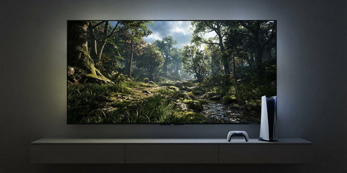 Konsola PS5 i kontroler DualSense na półce obok ekranu wyświetlającego grę.