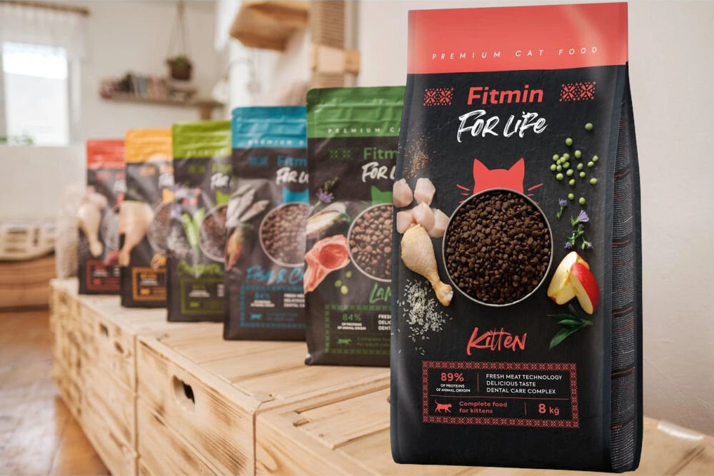 Karma dla kota FITMIN For Life Kitten Kurczak 8 kg opakowanie karmy na tle opakowanie innych smaków