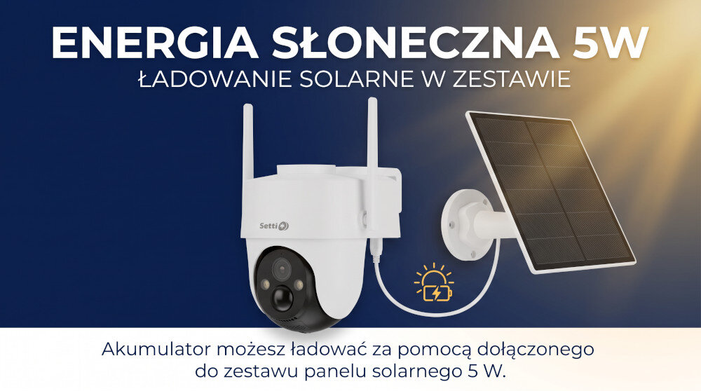 Osoba podłącza kabel USB do białego urządzenia, które wygląda na kamerę obrotową. Kamera ma czarny obiektyw i znajduje się na drewnianej powierzchni.