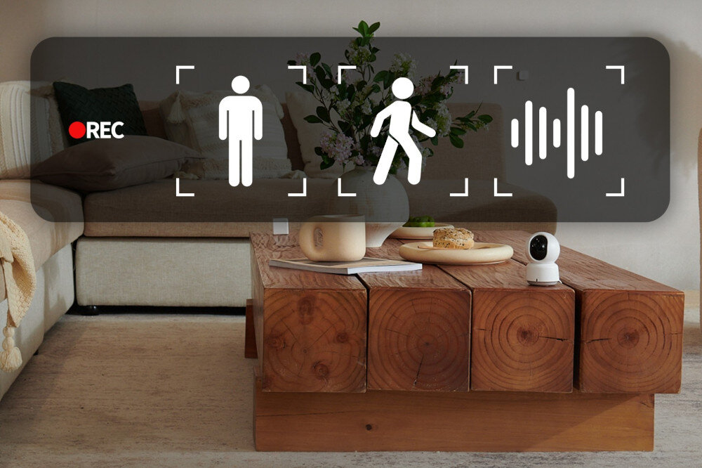 Kamera AQARA E1 CH-C01E - Reakcja na zdarzenia, kamera stojąca na drewnianym stole