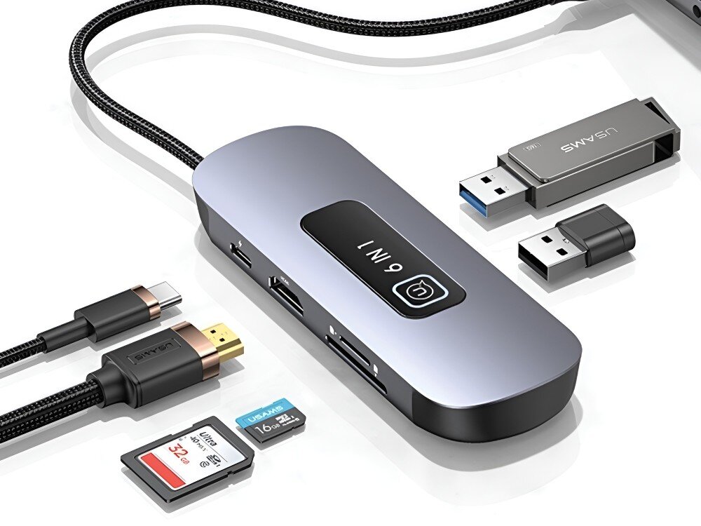 Hub USAMS SJ642HUB01 Hub USB-C z oznaczeniem 9 w 1 leży na białym tle wśród różnych akcesoriów, takich jak pendrive’y, karty pamięci, adaptery i przewody, 
            hub usbc 3.0 tf sd power delivery pd hdmi