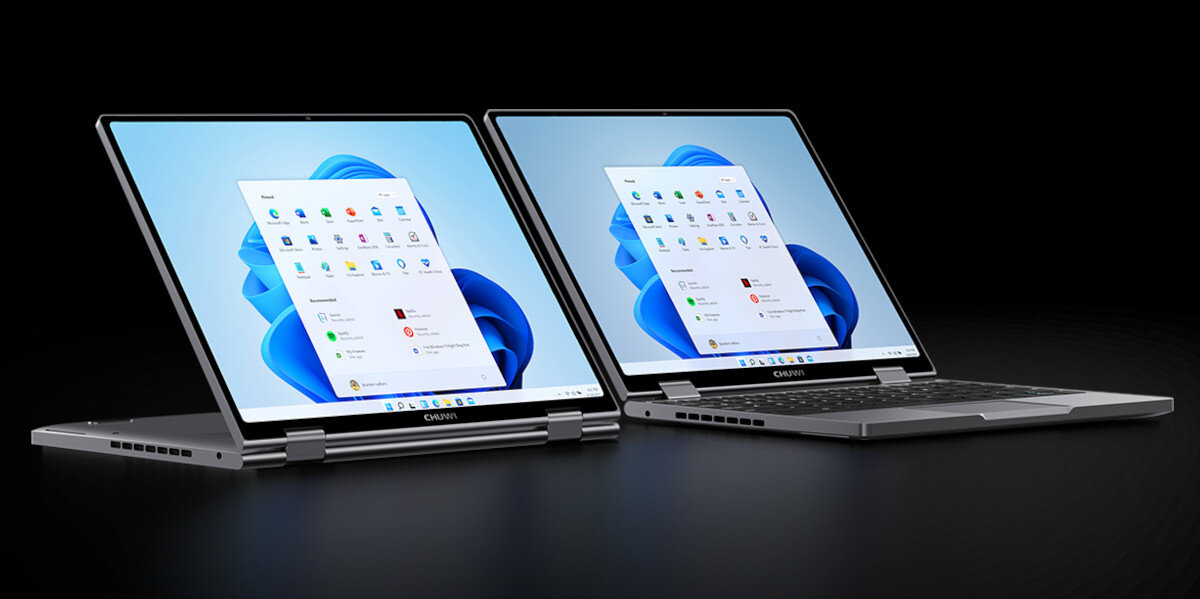 Dwa laptopy z identycznym ekranem i klawiaturą, ustawione obok siebie na biurku.   system funkcje