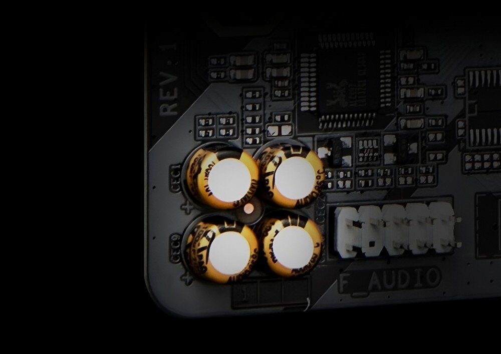 Płyta główna GIGABYTE B650 Gaming X AX V2 Cztery złote kondensatory audio umieszczone w rogu płyty głównej, obok oznaczenia 'F_Audio'