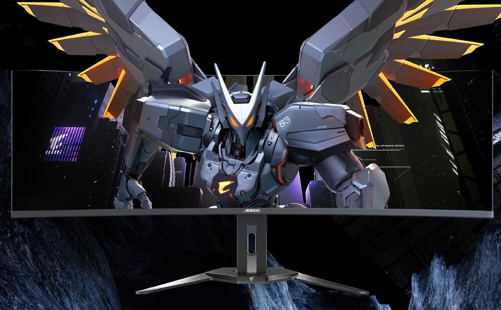 Monitor GIGABYTE AORUS CO49DQ Obraz przedstawia monitor z włączoną grą, na ekranie widoczny robot o futurystycznym wyglądzie z rozłożonymi skrzydłami. Monitor znajduje się w ciemnym, stylizowanym otoczeniu, opis