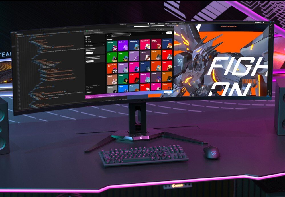 Monitor GIGABYTE AORUS CO49DQ Monitor na biurku wyświetlający jednocześnie edytor kodu oraz kolorową aplikację z ikonami kategorii. Otoczenie oświetlone różowo-niebieskimi światłami RGB, funkcje, ochrona przed wypaleniem, zabezpieczenia