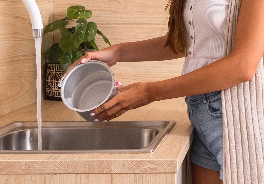 Maszynka do lodów CECOTEC Gelacy 800 osoba czyści miskę pod bieżącą wodą łatwe szybkie czyszczenie wyjmowana miska aluminiowa konstrukcja trwałość demontowalna forma mycie pod bieżącą wodą dokładne oczyszczanie higiena komfort użytkowania maszyny ułatwienie codziennej konserwacji urządzenia