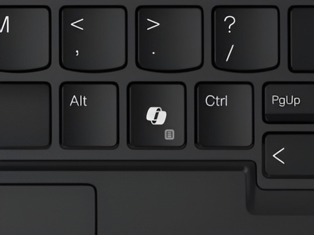 Zbliżenie na fragment czarnej klawiatury laptopa Lenovo ThinkPad X1 – widoczne klawisze Alt, dedykowany klawisz z ikoną aplikacji oraz Ctrl i PgUp; poniżej fragment touchpada. - klawisz Copilot, asystent, sztuczna inteligencja