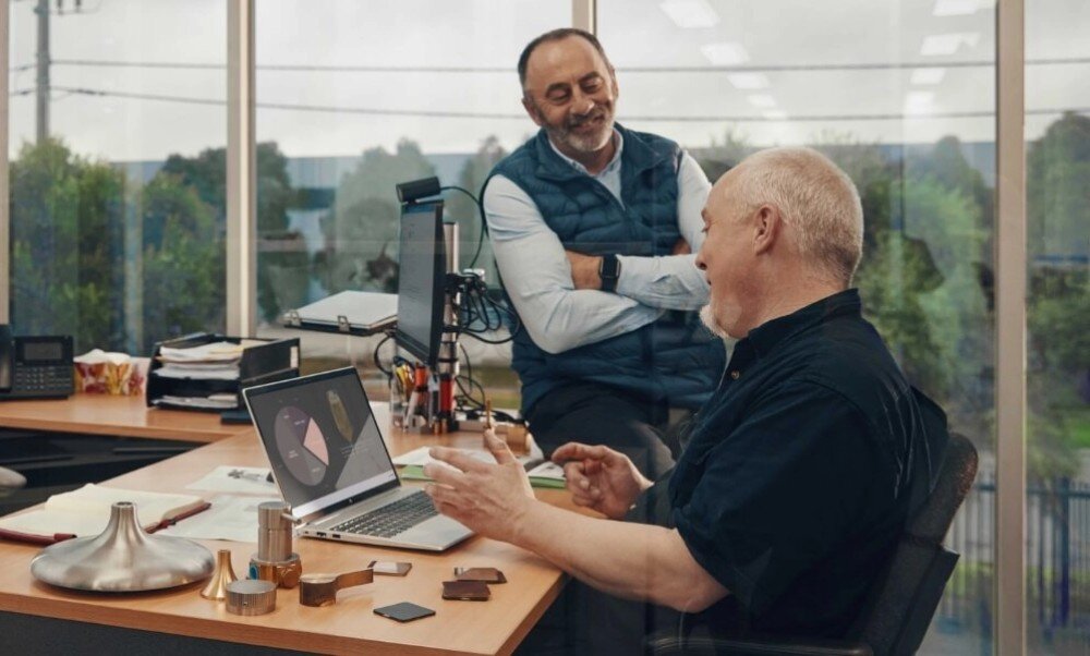 Laptop HP ProBook 440 G10 Dwóch mężczyzn w biurze przy biurku, jeden z nich używa laptopa z wykresami na ekranie, procesor, wydajność, taktowanie, rdzenie